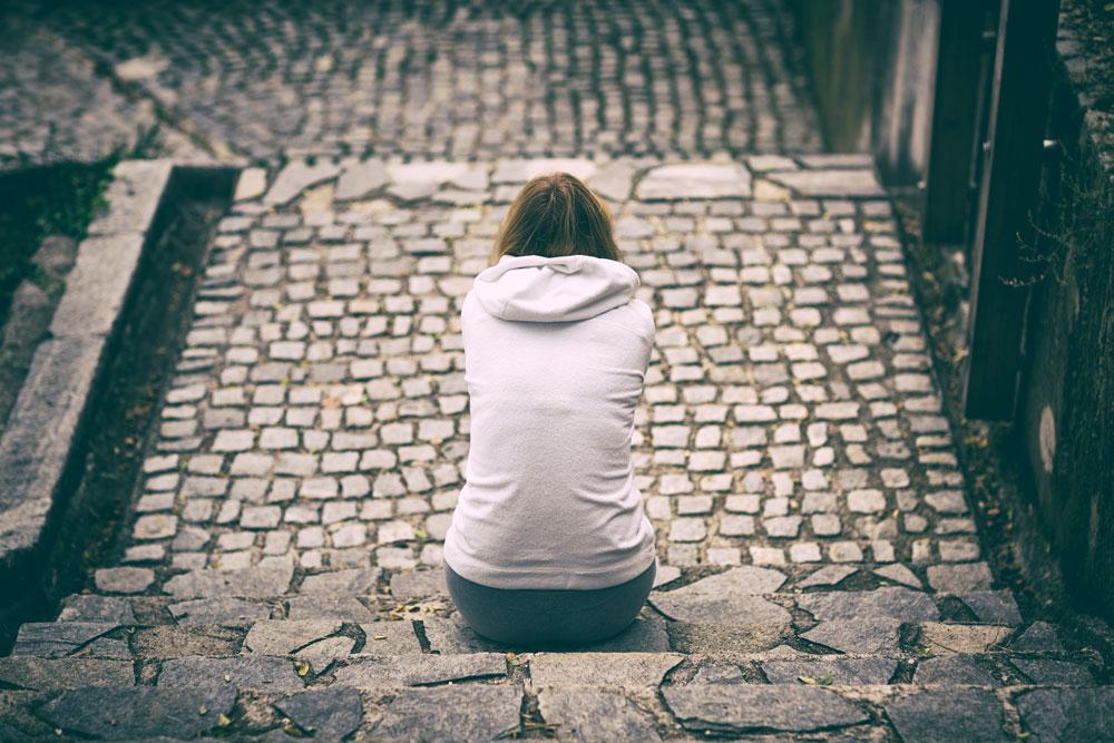 Teenager sitting alone